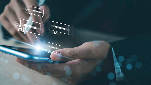 istock Hand holding smartphone with AI chatbot message icons, representing artificial intelligence, digital communication, and modern technology. 2220729279