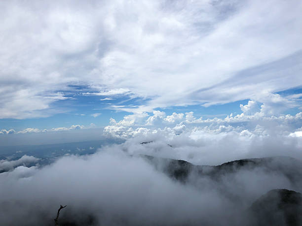 istock Majestic Mountain Peaks Emerging from a Sea of Clouds 2220731971