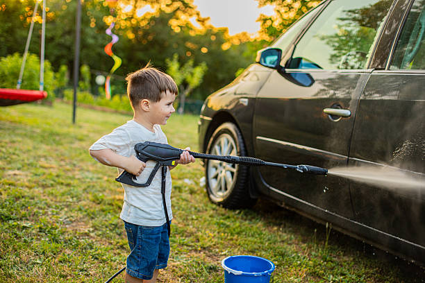 Boy Having Fun Helping Parents Clean the Car