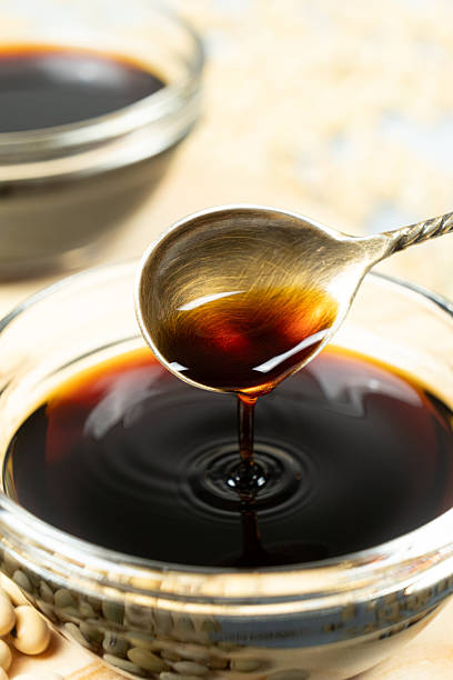 istock Soy sauce poured from a spoon into a saucepan close-up 2220732742