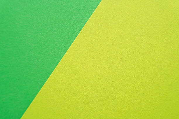 istock Neon green and yellow paper in a sharp diagonal composition. 2220732905