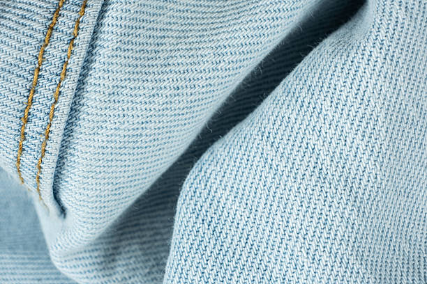 istock Detailed View of Blue Jeans Fabric and Thread Stitching 2220735421