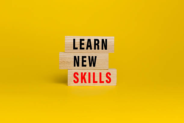 istock learn new skills words text on wooden blocks isolated on yellow background 2220736401