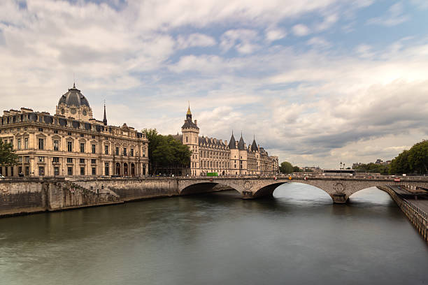 istock Conciergerie and Seine River bridge in Paris on a cloudy day 2220737653