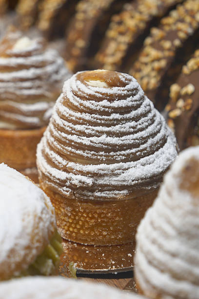 istock An array of pastries and eclairs are presented in the bakery display case with allure 2220738502