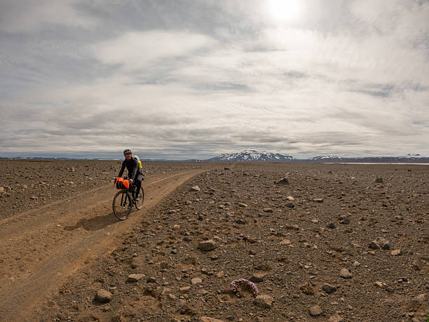 istock Bikepacking: Navigating Rocky Desert Road with Mountain View 2220739656