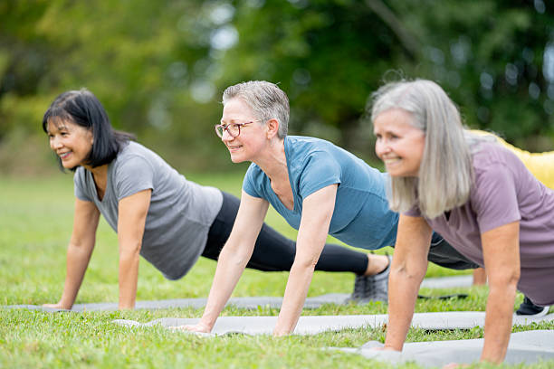 istock Senior Women Exercising Outdoors While Doing Yoga or Fitness Training 2220739883