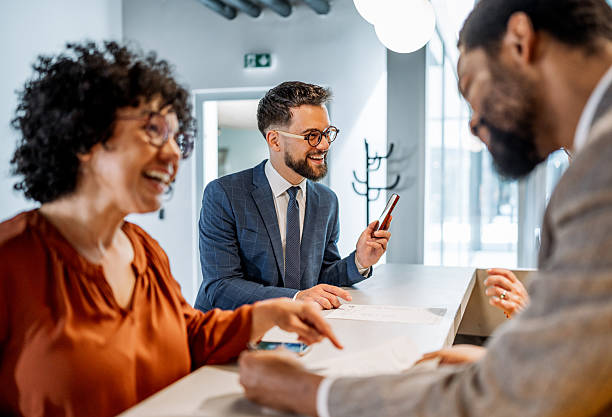 istock Businesspeople checking in at hotel reception 2220740078