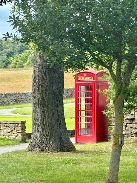 istock Red old fashioned telephone box in the countryside 2220740179