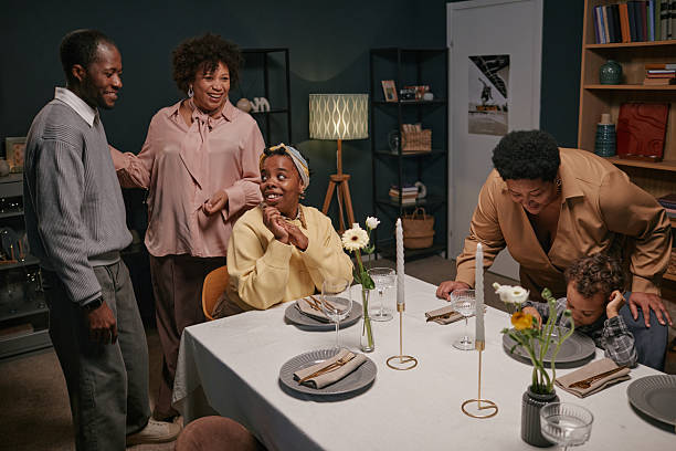 istock Happy Family Gathering around Dinner Table Smiling and Chatting 2220740222