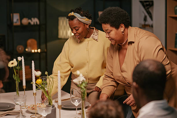 istock Black Women Setting Dinner Table during Family Gathering at Home 2220740243