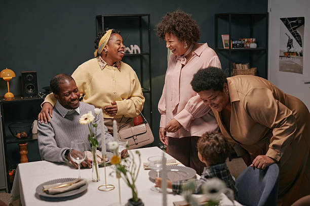 istock Black Family Chatting with Laughter at Festive Home Dinner 2220740287