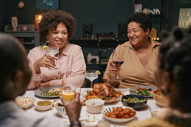 istock Black Family Celebrating Holiday during Dinner with Festive Table Setting 2220740296
