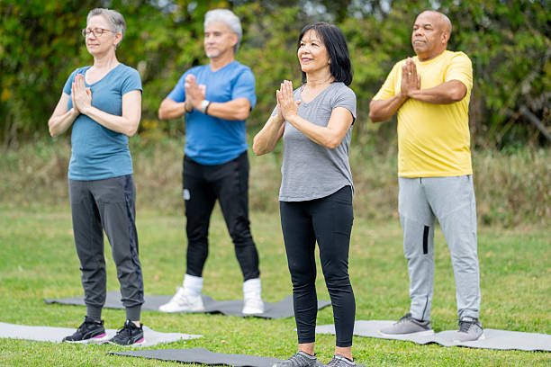 istock Group of Seniors Practicing Yoga Outdoors in a Relaxing Natural Setting 2220740360