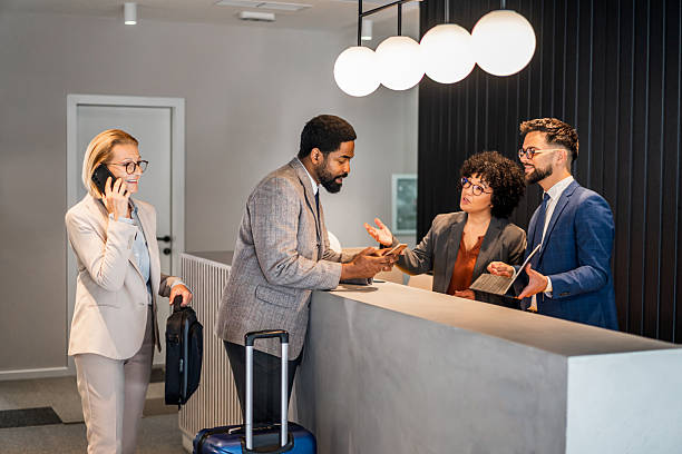 istock Businesspeople checking in at hotel reception 2220740428