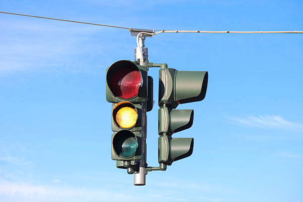 istock Hanging traffic light with the yellow light on. 2220741158