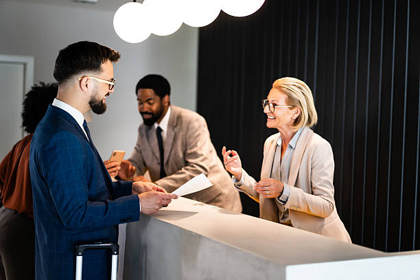 istock Businessman checking in at hotel reception 2220741353