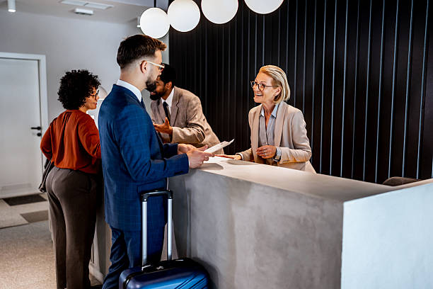 istock Businessman checking in at hotel reception 2220741415