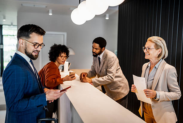 istock Businesspeople waiting at hotel reception desk 2220741690