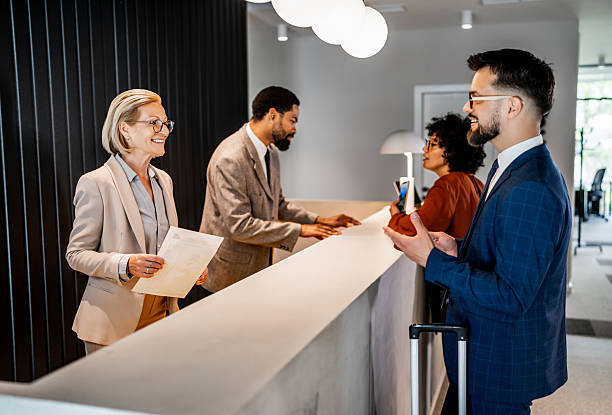 istock Businesspeople checking in at hotel reception 2220741716
