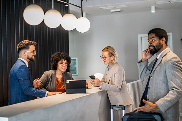 istock Businesspeople checking in at hotel reception 2220742174