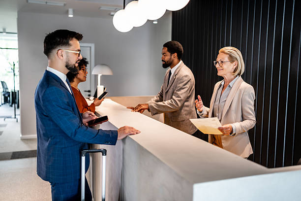 istock Businesspeople checking in at hotel reception 2220742185