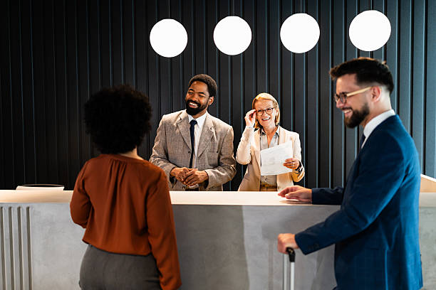 istock Businesspeople checking in at hotel reception 2220742294