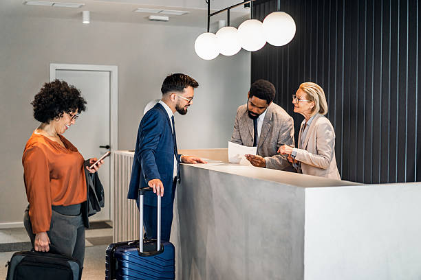 istock Businesspeople checking in at hotel reception 2220742736