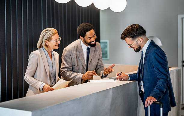 istock Businessman checking in at hotel reception 2220742790