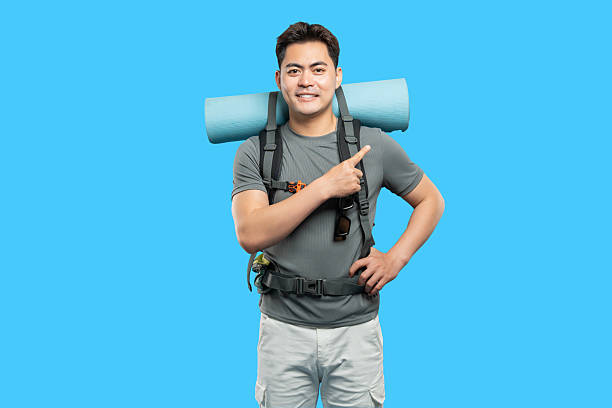 istock Enthusiastic hiker in adventure gear points to the side ready for the trails ahead 2220743345