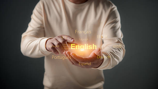 A person's hands delicately hold a glowing English text, surrounded by other languages, symbolizing global communication, language learning, and the importance of English as a universal medium.