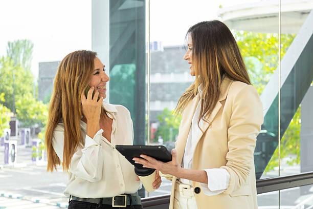 istock Businesswomen talking and using digital tablet and smartphone in office building 2220744657