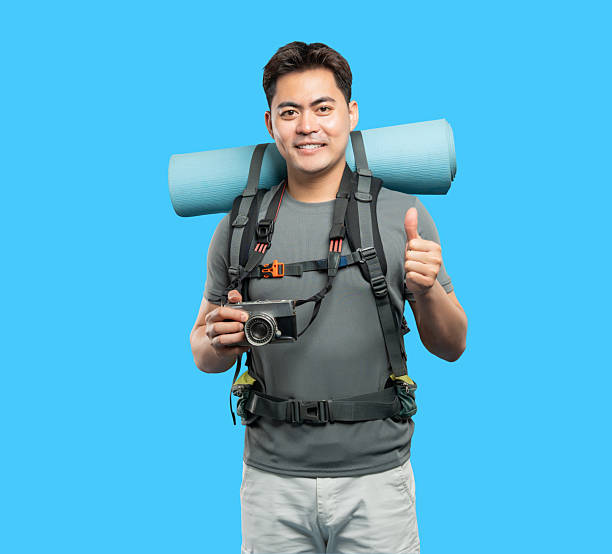 istock Smiling Hiker Giving Thumbs Up with Camera and Backpack - Ready for outdoor adventure 2220746768