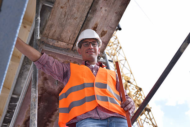 istock portrait smiling  construction manager / architect on site during the construction of a house - planning and control on site 2220746942