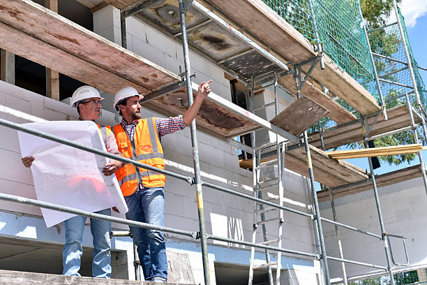 istock construction manager and architect on site during the construction of a house - planning and control on site - teamwork 2220746948