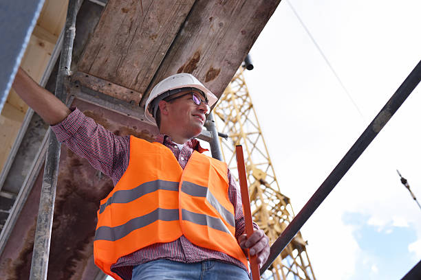 istock portrait smiling  construction manager / architect on site during the construction of a house - planning and control on site 2220746997