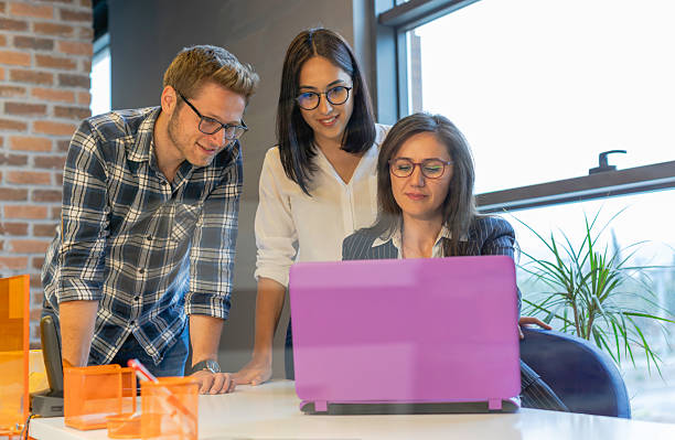 istock Young Couple Consulting with Female Professional in Modern Office Setting 2220749656