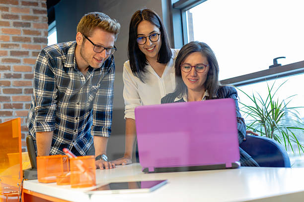 istock Young Couple Consulting with Female Professional in Modern Office Setting 2220749675