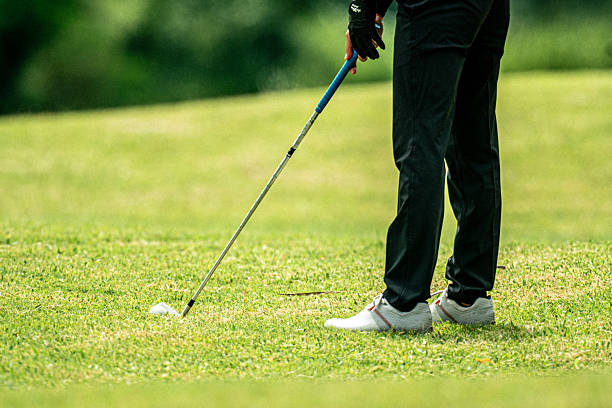 istock A man is standing on a golf course with a golf club in his hand 2220750192