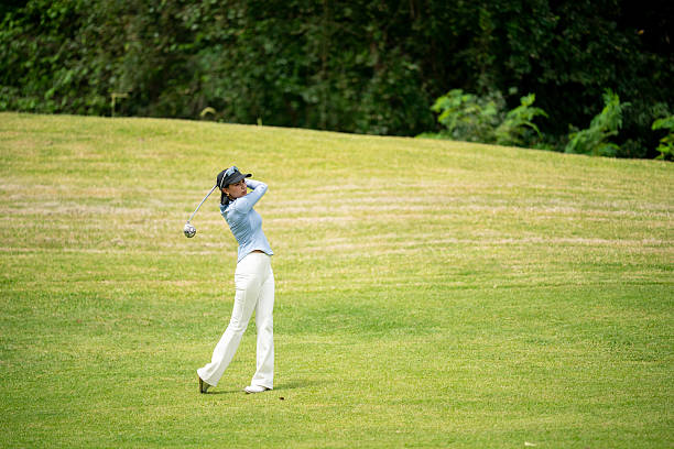 istock A woman is playing golf on a grassy field 2220750202