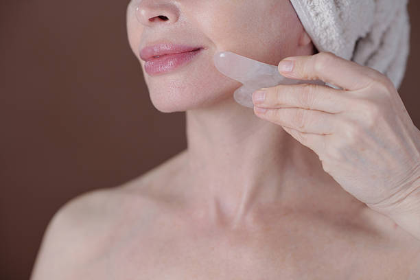 istock Woman Doing Facial Massage with Quartz Gua Sha Tool 2220750487