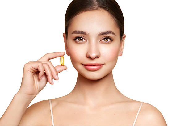 istock Beautiful Girl With Pill With Cod Liver Oil Omega-3 2220752539