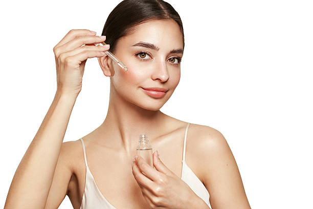 istock Young beautiful woman applying face serum 2220752631