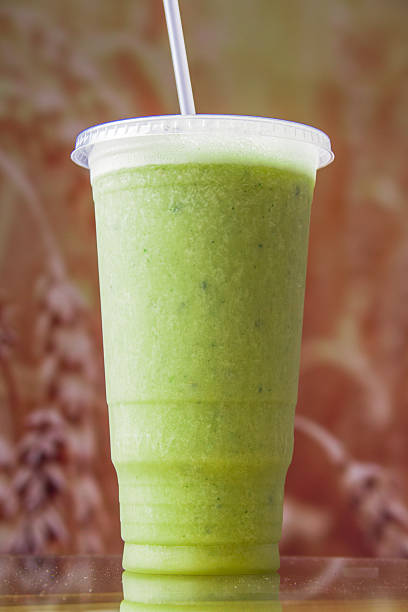 istock A nutritious green smoothie served in a transparent cup with a straw, highlighting its fresh ingredients, ideal for health-conscious individuals looking for a quick snack. 2220754539
