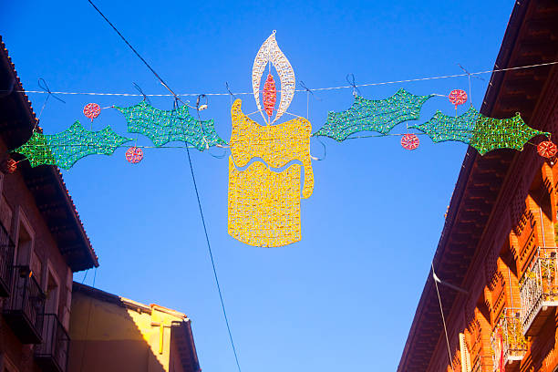 candle and holly . Christmas celebration, decoration .  Alcalá de Henares, Madrid, Spain.