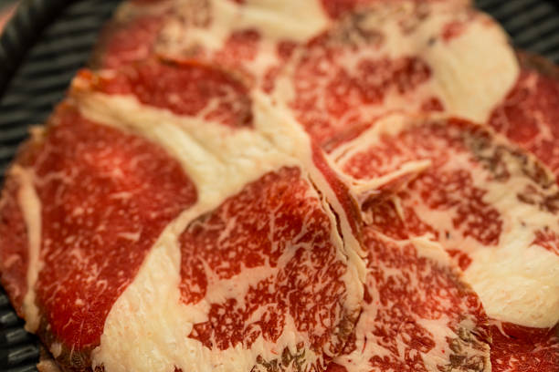 Thinly sliced raw beef prepared for hotpot or sukiyaki