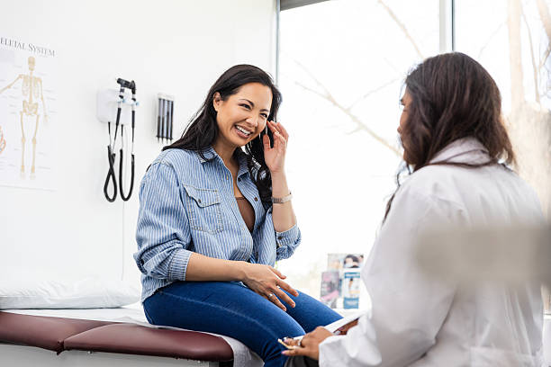 istock Happy Patient Talking with Female Doctor in Office 2220760723