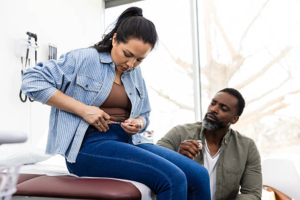 istock Woman Self-Administering Insulin Injection with Husband's Assistance 2220760753