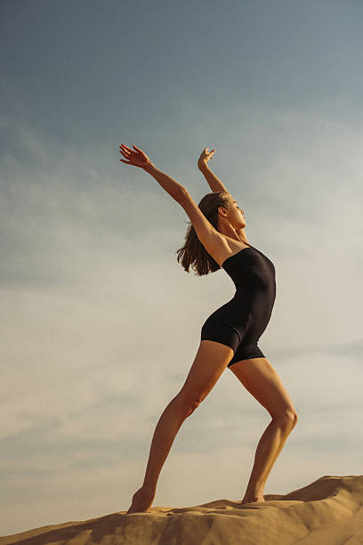 istock Young woman posing gracefully outdoors under a clear blue sky 2220762761