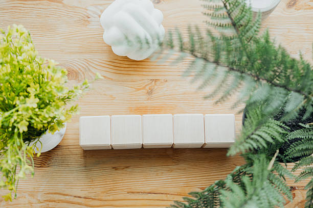 Wooden blocks mockup top view on rustic wood with decorative greenery